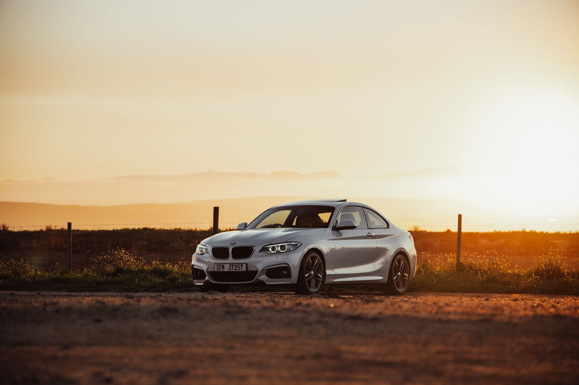 Parked white BMW coupe, cross-border trip in the Balkans